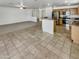 Open-concept living space with tile and carpet, seamlessly connecting the kitchen and living areas at 16370 W Rimrock St, Surprise, AZ 85388