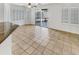 Bright living area featuring tile floors, plantation shutters, and a sliding glass door to the patio at 16370 W Rimrock St, Surprise, AZ 85388