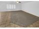 Spacious living room with tile flooring and carpet, enhanced by natural light from large windows at 16370 W Rimrock St, Surprise, AZ 85388