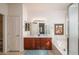 Main bathroom with dual sinks, soaking tub, and a separate glass enclosed shower at 16949 W Oasis Springs Way, Surprise, AZ 85387