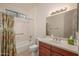 Bathroom featuring a shower-tub combo with a floral curtain and single sink vanity at 16949 W Oasis Springs Way, Surprise, AZ 85387