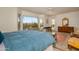 Spacious main bedroom featuring natural light, a large bed, and a sitting area at 16949 W Oasis Springs Way, Surprise, AZ 85387