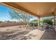 The covered patio is ideal for outdoor dining and entertaining with the desert landscape at 16949 W Oasis Springs Way, Surprise, AZ 85387