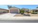 Charming single-story home featuring a two-car garage and desert landscaping at 16949 W Oasis Springs Way, Surprise, AZ 85387