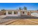 Backyard featuring a covered patio, a white shed, and desert landscaping at 1716 W Weldon Ave, Phoenix, AZ 85015