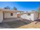 Backyard featuring a storage shed, a covered carport, and a grassy area at 1716 W Weldon Ave, Phoenix, AZ 85015