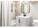 Clean bathroom features updated vanity, mirror, and shower with modern fixtures at 1716 W Weldon Ave, Phoenix, AZ 85015