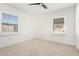 Cozy bedroom features neutral carpet, a modern ceiling fan and bright, natural light at 1716 W Weldon Ave, Phoenix, AZ 85015