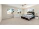 Well-lit primary bedroom features plush carpeting, a ceiling fan and abundant natural light at 1716 W Weldon Ave, Phoenix, AZ 85015