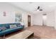 Bright living room with neutral walls, tile floors, and a comfortable blue couch at 1716 W Weldon Ave, Phoenix, AZ 85015