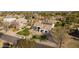 Aerial view of a beautiful home, green lawns, solar panels, and a sparkling pool at 19864 E Via Del Oro --, Queen Creek, AZ 85142