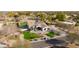 An impressive aerial view of the home, landscaped yard, inviting pool, and solar panels on roof in a neighborhood at 19864 E Via Del Oro --, Queen Creek, AZ 85142