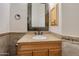 Cozy bathroom features warm colored tile, granite countertop and custom mirror at 19864 E Via Del Oro --, Queen Creek, AZ 85142