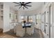 Bright dining area with a round table, six chairs, and built-in shelving at 19864 E Via Del Oro --, Queen Creek, AZ 85142