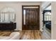 Stylish entryway with rich hardwood floors, a dark wood door, and an arched window with plantation shutters at 19864 E Via Del Oro --, Queen Creek, AZ 85142