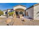 Elegant home entrance with stone walkway, manicured landscaping, and architectural details under a covered entryway at 19864 E Via Del Oro --, Queen Creek, AZ 85142