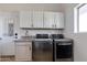 Well-equipped laundry room with cabinets, sink, modern stainless steel washer and dryer at 19864 E Via Del Oro --, Queen Creek, AZ 85142