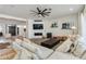 Inviting living room featuring a fireplace, modern ceiling fan, and comfortable sectional sofa at 19864 E Via Del Oro --, Queen Creek, AZ 85142