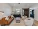 Open living room featuring modern furniture, a cozy rug, and arched windows providing natural light at 19864 E Via Del Oro --, Queen Creek, AZ 85142