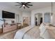 This spacious main bedroom features wood floors, a ceiling fan, and neutral colors at 19864 E Via Del Oro --, Queen Creek, AZ 85142