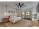 Serene main bedroom with soft carpet, pendant lighting, and a large window for natural light at 19864 E Via Del Oro --, Queen Creek, AZ 85142