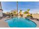 Backyard swimming pool features rock features and palm trees at 19864 E Via Del Oro --, Queen Creek, AZ 85142