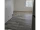 Bedroom with wood-look floors and a window providing natural light at 21748 W Sonora St, Buckeye, AZ 85326