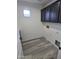 Laundry room with grey cabinets and wood-look floors at 21748 W Sonora St, Buckeye, AZ 85326