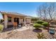 Private backyard with desert landscaping, covered patio, brick pavers, and mature trees at 22754 W Moonlight Path, Buckeye, AZ 85326