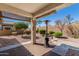 Covered patio area overlooking a private backyard featuring low maintenance desert landscaping at 22754 W Moonlight Path, Buckeye, AZ 85326