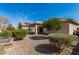 Private backyard with desert landscaping, covered patio, and mature trees offering shade at 22754 W Moonlight Path, Buckeye, AZ 85326