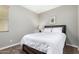 Cozy bedroom with neutral walls and carpet, featuring a wooden bed frame and ample natural light at 22754 W Moonlight Path, Buckeye, AZ 85326