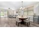 Open floor plan living room and dining area with neutral tones, wood-look tile, and lots of natural light at 22754 W Moonlight Path, Buckeye, AZ 85326