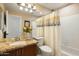 Well-lit bathroom with a granite vanity, a toilet, and a shower-tub combination at 23843 N 73Rd St, Scottsdale, AZ 85255