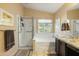 Bright bathroom with a glass-enclosed shower, soaking tub, and granite-topped vanity at 23843 N 73Rd St, Scottsdale, AZ 85255