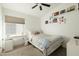 Bright bedroom with a ceiling fan, desk, and a window that provides natural light at 23843 N 73Rd St, Scottsdale, AZ 85255