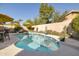 Backyard pool with lush landscaping and patio furniture, perfect for outdoor relaxation and entertaining at 23843 N 73Rd St, Scottsdale, AZ 85255