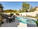 Backyard pool with a patio table and chairs, surrounded by lush landscaping for relaxation and outdoor enjoyment at 23843 N 73Rd St, Scottsdale, AZ 85255