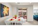 Bright dining area featuring a modern white table set and a sliding glass door to a patio at 2425 W Bronco Butte Trl # 2024, Phoenix, AZ 85085