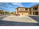 Exterior of a multi-story home featuring a two-car garage, desert landscaping, and a private staircase at 2425 W Bronco Butte Trl # 2024, Phoenix, AZ 85085