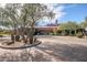 Expansive circular driveway leading to a luxurious home with a red roof and desert landscaping at 2425 W Bronco Butte Trl # 2024, Phoenix, AZ 85085