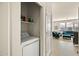 Convenient laundry area featuring a washing machine, storage shelves, and easy access to the living space at 2425 W Bronco Butte Trl # 2024, Phoenix, AZ 85085