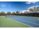 Outdoor tennis court featuring blue and green surface surrounded by a black fence and desert landscaping at 2425 W Bronco Butte Trl # 2024, Phoenix, AZ 85085