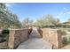 Scenic walking bridge with stone pillars, offering a charming pathway through the community at 2425 W Bronco Butte Trl # 2024, Phoenix, AZ 85085