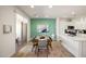 Bright dining area connected to a modern kitchen with white cabinets and stainless steel appliances at 2425 W Bronco Butte Trl # 2030, Phoenix, AZ 85085