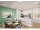 Bright dining area connected to a modern kitchen with white cabinets and stainless steel appliances at 2425 W Bronco Butte Trl # 2030, Phoenix, AZ 85085