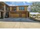 Two-story condo exterior with a two-car garage and desert landscaping at 2425 W Bronco Butte Trl # 2030, Phoenix, AZ 85085