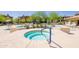 Community hot tub with surrounding desert landscaping and lounge chairs at 2425 W Bronco Butte Trl # 2030, Phoenix, AZ 85085