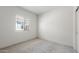 A bright bedroom featuring neutral carpet, a window, and neutral-colored walls at 24653 W Concorda Dr, Buckeye, AZ 85326