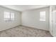 This bedroom features neutral carpet, two large windows and light-colored walls at 2528 S 244Th Dr, Buckeye, AZ 85326